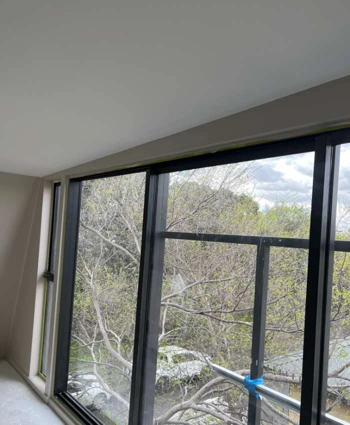 Painted ceiling and walls around a masked sliding window