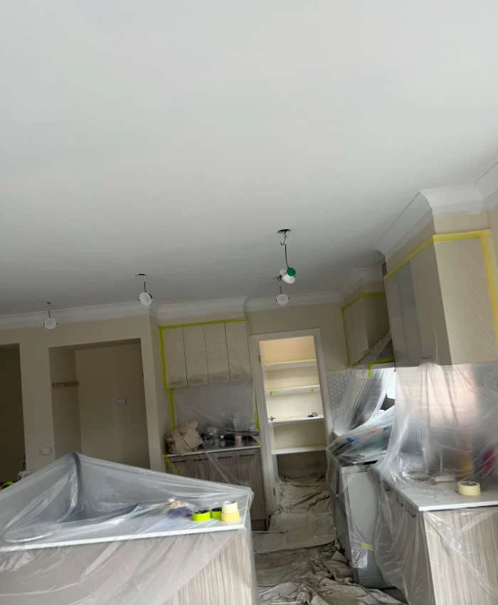 Home painting project with kitchen surfaces protected