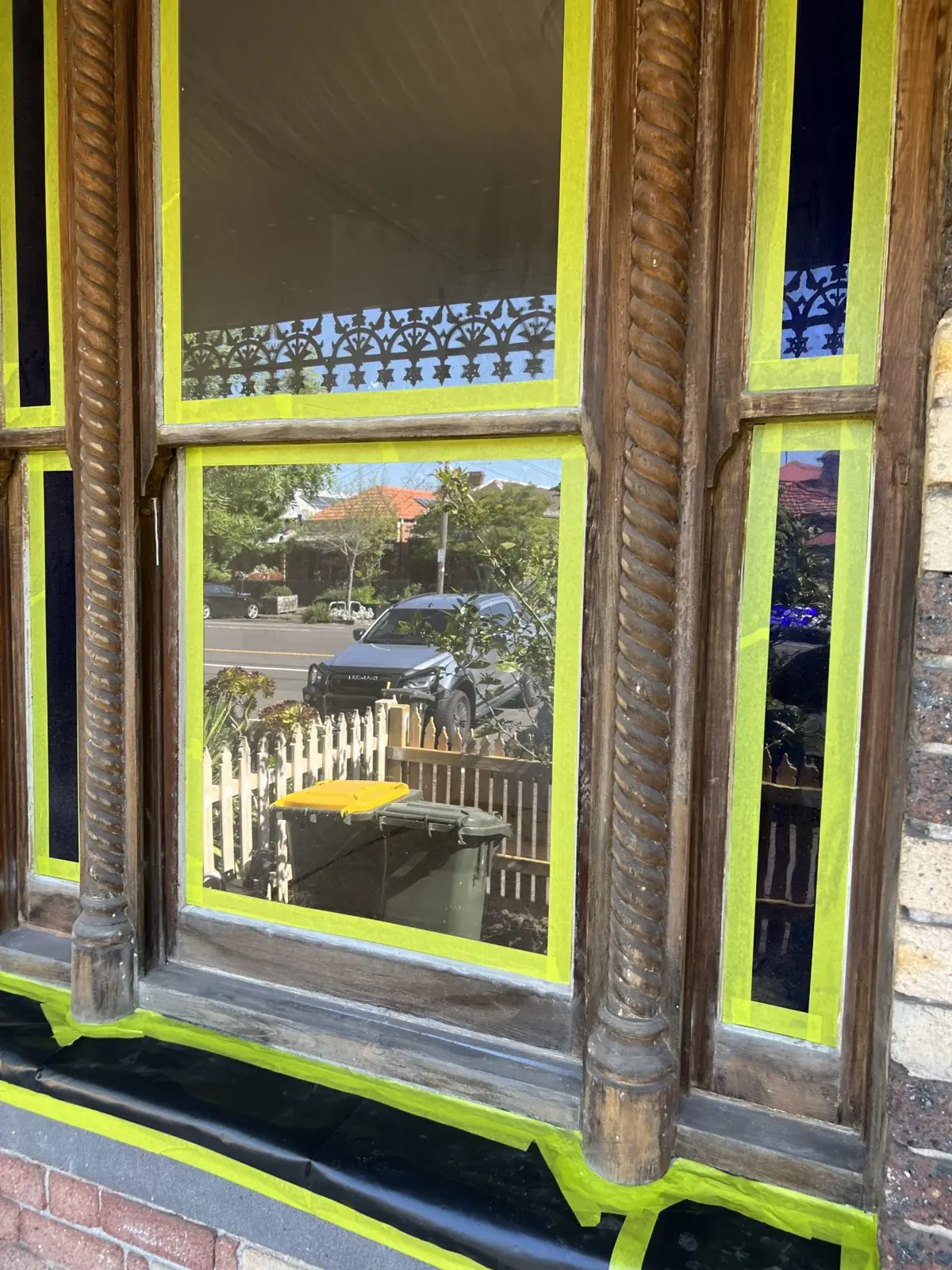 Exterior window protected with masking tape